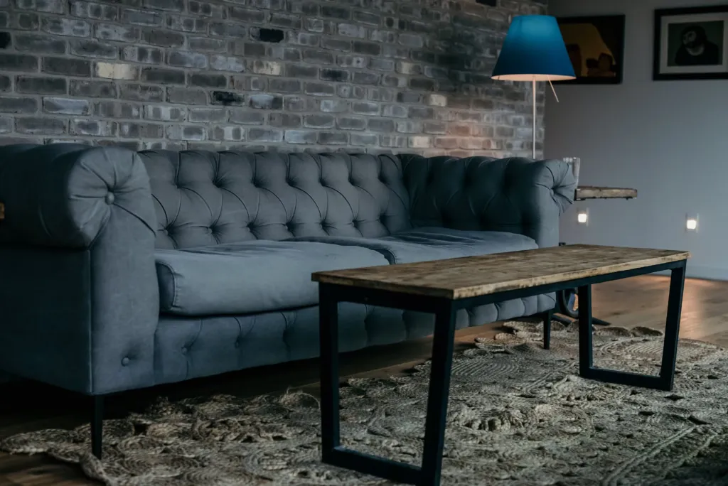 Grey couch and a wooden coffee table
